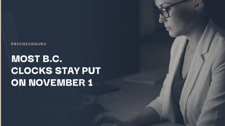 Woman in glasses and a white blazer typing at a desk in a dark office at night, illustrating payroll checks for B.C. staying on permanent daylight saving time.